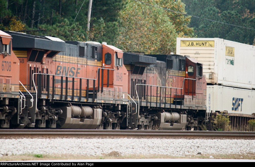 BNSF 6648 and 5393 run third and fourth in a quartet of units